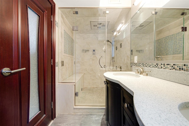 bathroom with vanity, walk in shower, and backsplash