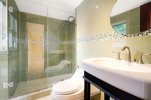 bathroom featuring tile patterned floors, toilet, decorative backsplash, vanity, and tile walls