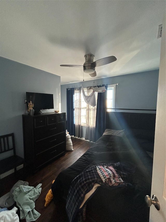 bedroom featuring ceiling fan and dark hardwood / wood-style floors