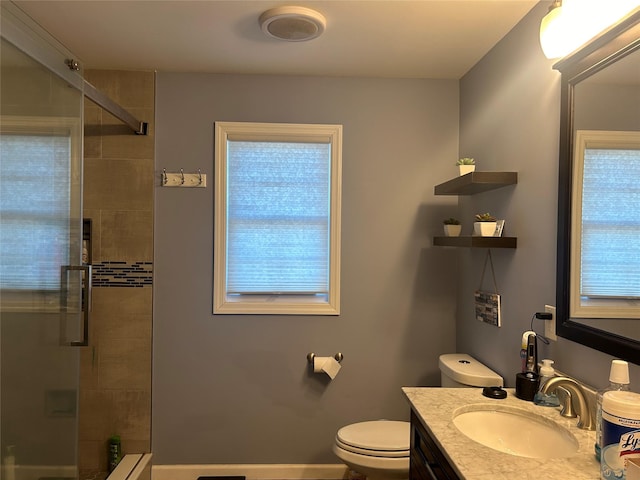 bathroom with vanity, an enclosed shower, and toilet