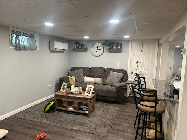 living room with dark wood-type flooring and a wall unit AC