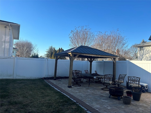 view of patio featuring a gazebo and an outdoor fire pit