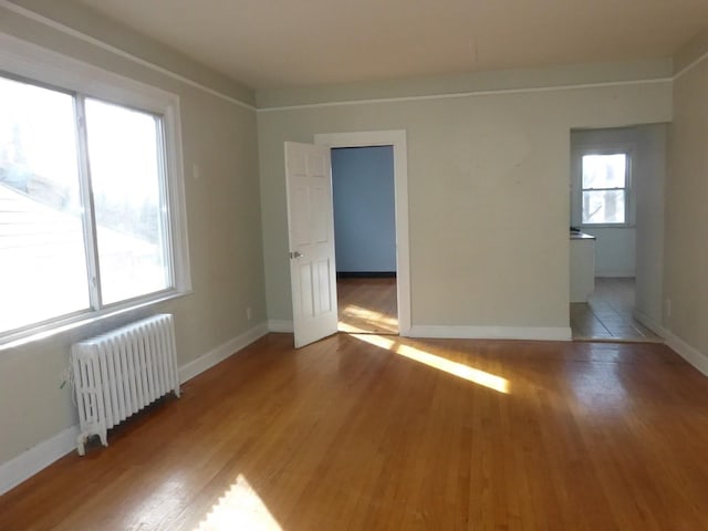 spare room with hardwood / wood-style floors and radiator