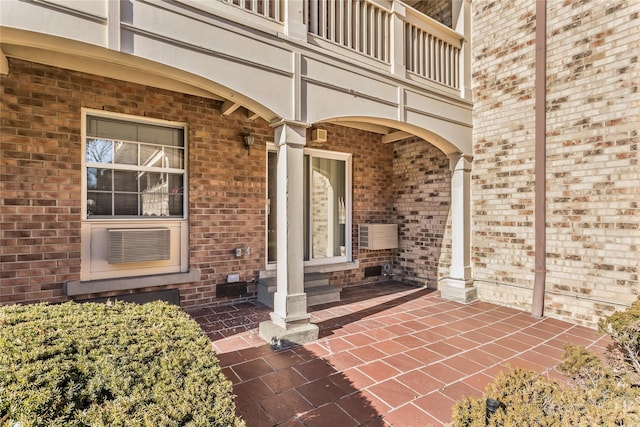 property entrance with a balcony and a patio