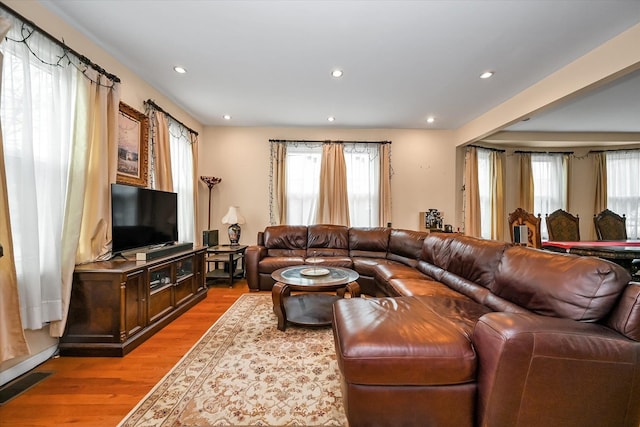 living area featuring light wood-type flooring, visible vents, a wealth of natural light, and recessed lighting