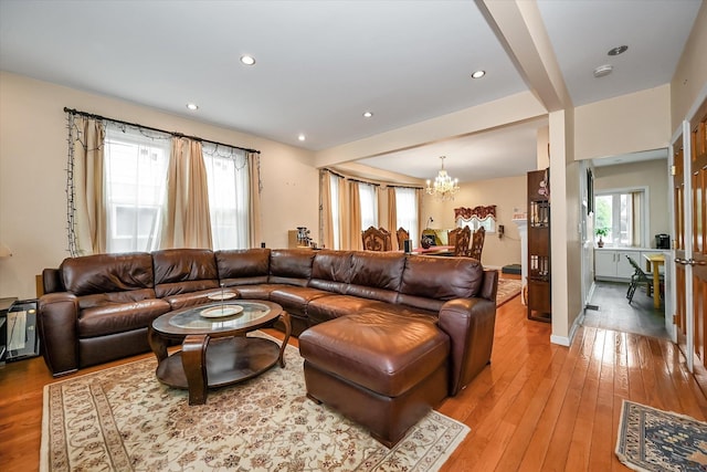 living room featuring a notable chandelier, recessed lighting, baseboards, and light wood-style floors