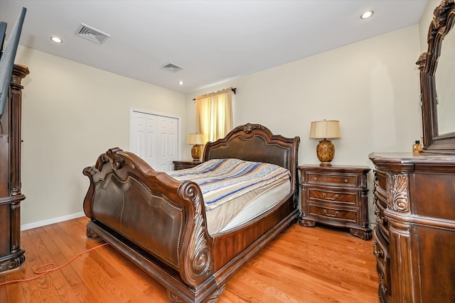 bedroom with light hardwood / wood-style flooring and a closet