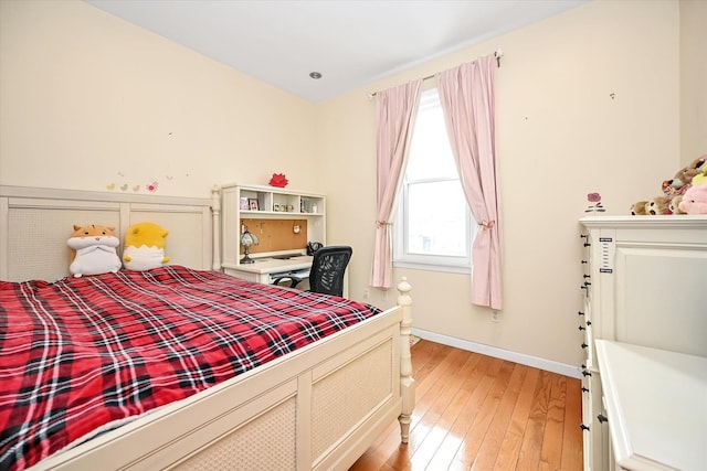 bedroom featuring multiple windows and light hardwood / wood-style flooring