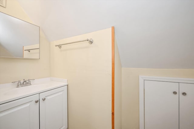 bathroom with vanity and vaulted ceiling