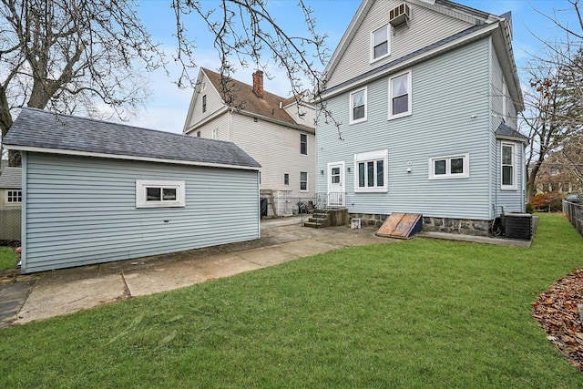 back of house featuring a yard and central AC unit