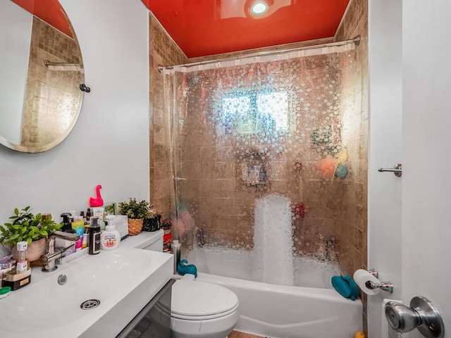 full bathroom with shower / bath combo with shower curtain, sink, and toilet