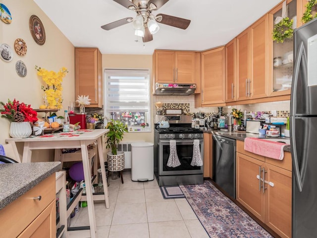 kitchen with backsplash, ceiling fan, light tile patterned floors, and stainless steel appliances