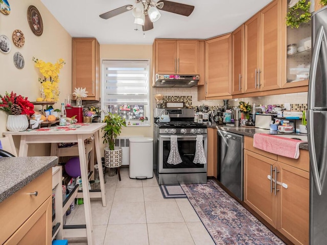 kitchen featuring ceiling fan, light tile patterned flooring, backsplash, and appliances with stainless steel finishes