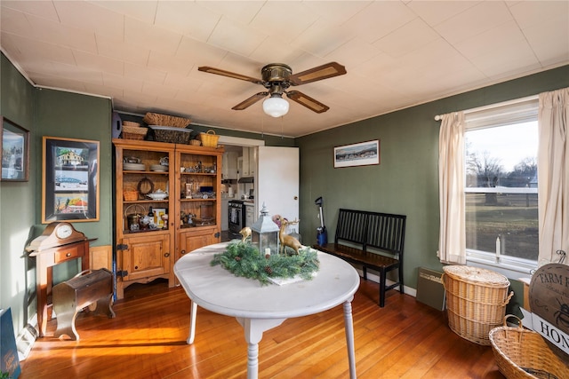 dining room with ceiling fan and hardwood / wood-style flooring