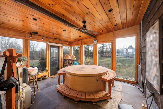 sunroom with beam ceiling, ceiling fan, wood ceiling, and track lighting