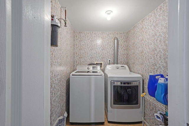 clothes washing area with independent washer and dryer