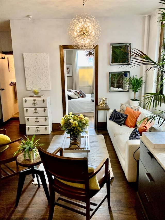 living room featuring an inviting chandelier and dark wood-type flooring