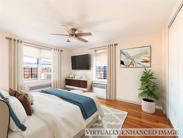 bedroom featuring multiple windows, light hardwood / wood-style floors, and radiator