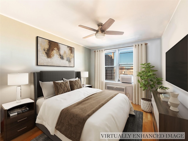 bedroom featuring radiator, ceiling fan, cooling unit, and hardwood / wood-style flooring