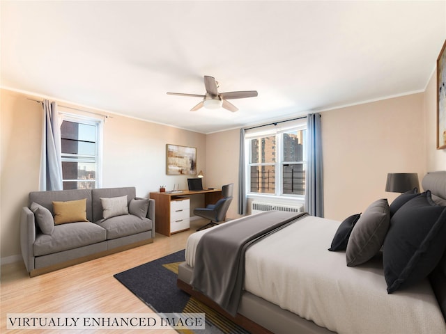 bedroom featuring radiator heating unit, light hardwood / wood-style floors, crown molding, and ceiling fan