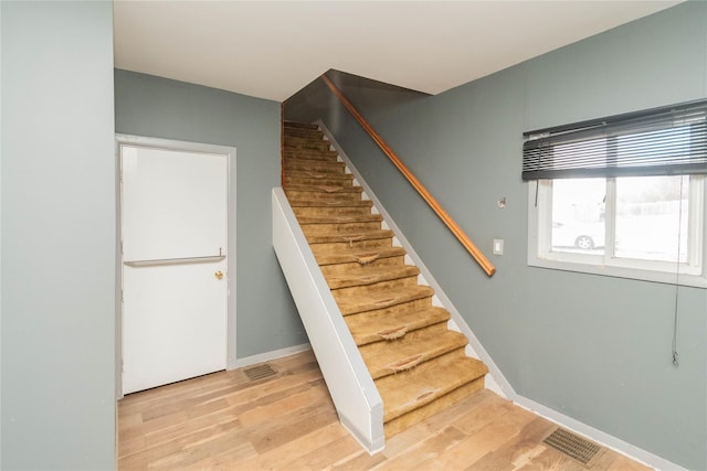 stairway with hardwood / wood-style floors