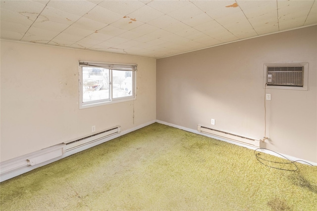 carpeted spare room featuring baseboard heating and a wall unit AC