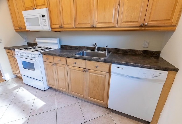 kitchen featuring light tile patterned floors, sink, and white appliances