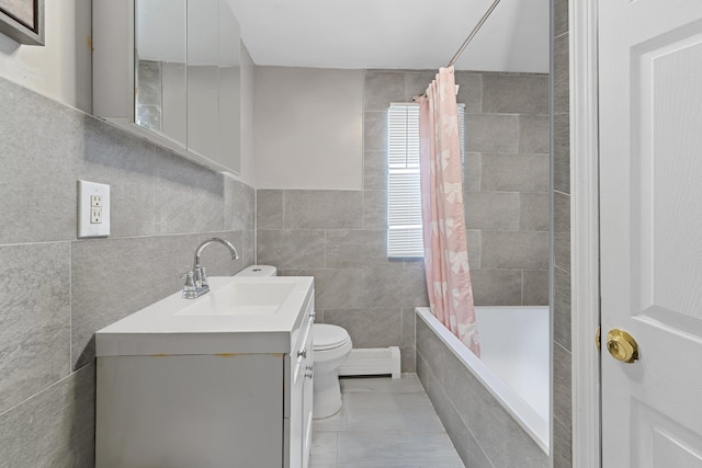 full bathroom with toilet, a baseboard radiator, tile walls, shower / tub combo, and vanity