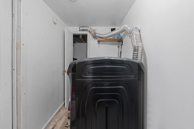 laundry area with light wood-type flooring and washer / dryer