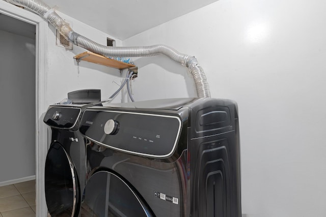 washroom with washer and dryer and tile patterned floors