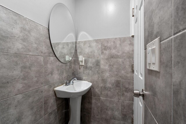 bathroom with tile walls