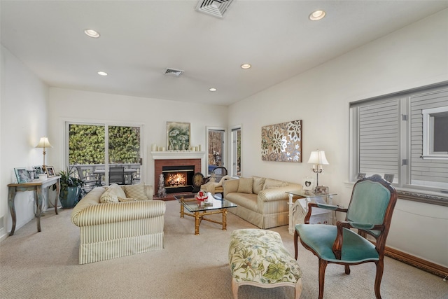 living room with light colored carpet and a fireplace