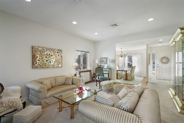 living room with light carpet and a chandelier