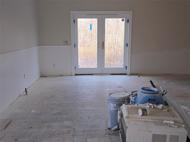 unfurnished room featuring french doors