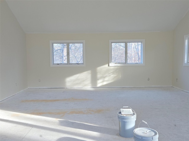 unfurnished room featuring vaulted ceiling