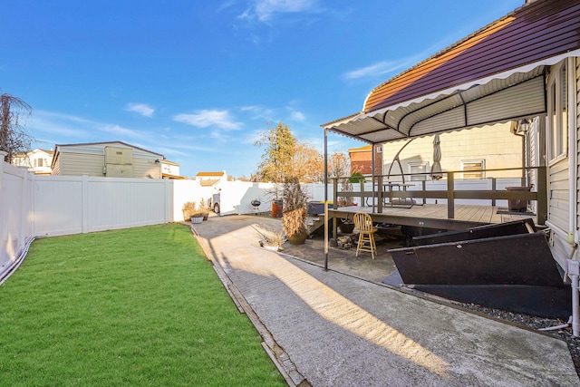 view of yard with a wooden deck and a patio area