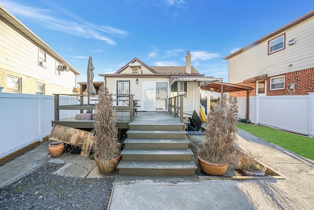 rear view of house featuring a deck