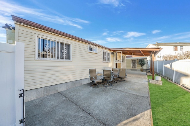 rear view of property with a patio area and a lawn