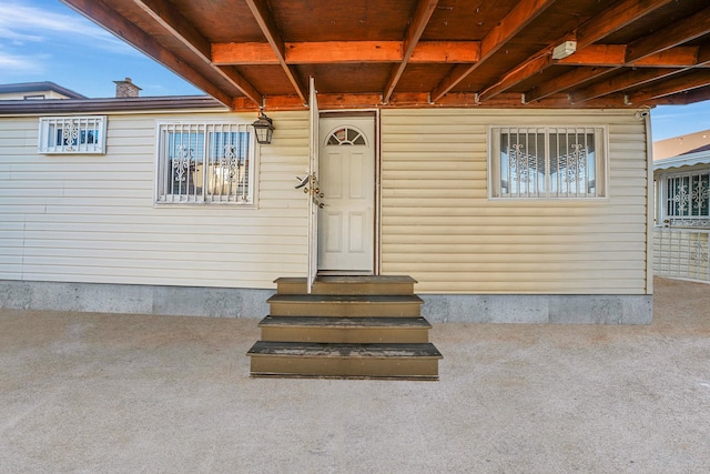 view of exterior entry with a patio