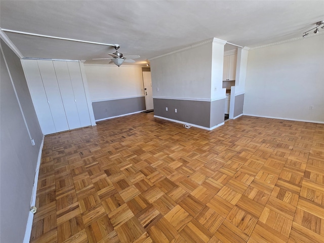 spare room featuring ceiling fan, light parquet flooring, and crown molding