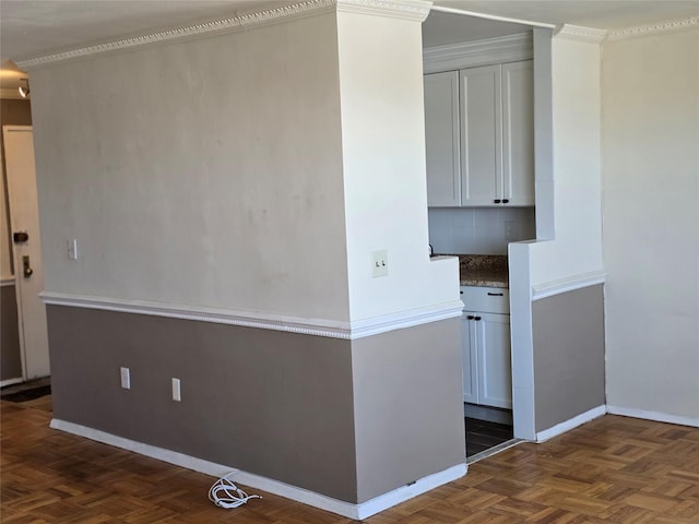 interior space with crown molding and dark parquet flooring