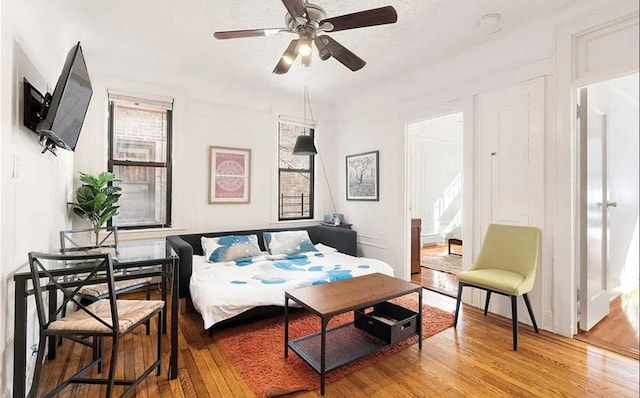 bedroom featuring ensuite bath, ceiling fan, and light hardwood / wood-style flooring