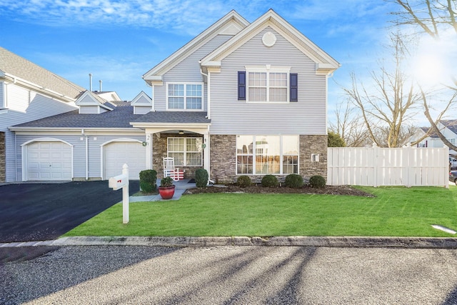 view of front of house featuring a front yard and a garage