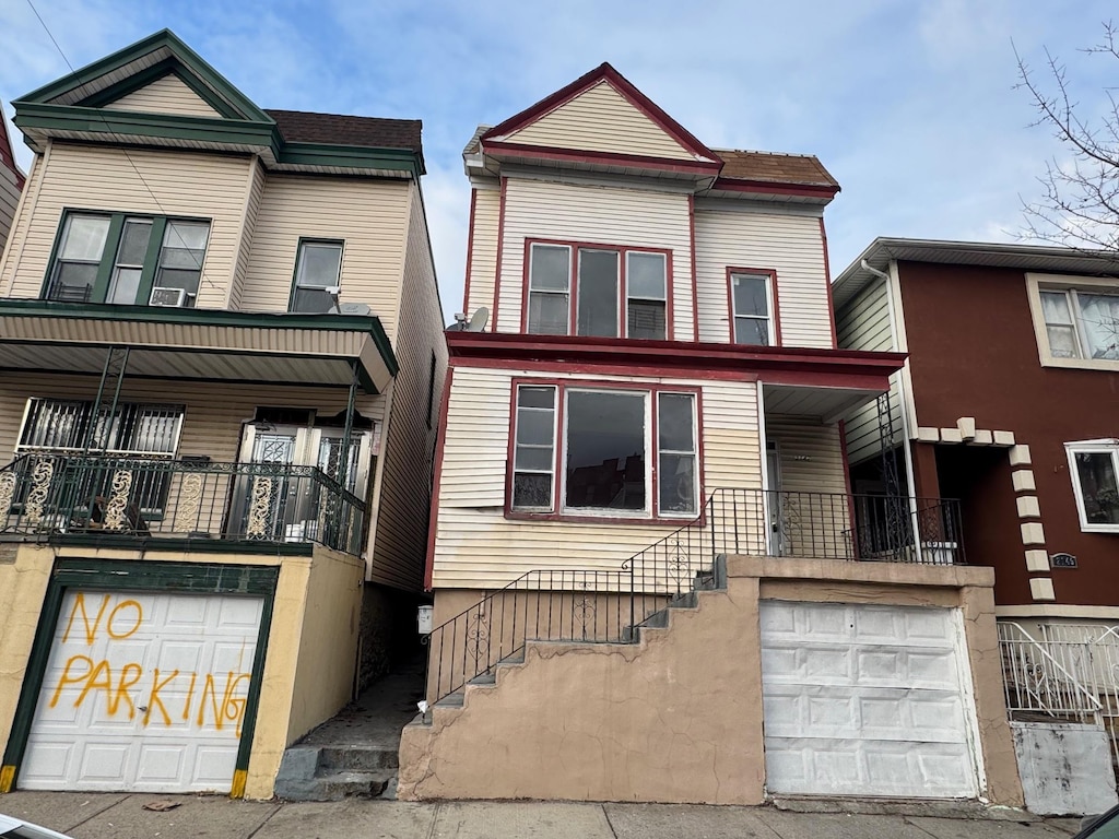 townhome / multi-family property featuring a balcony and a garage