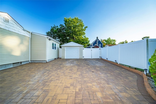 view of patio / terrace with a garage and an outdoor structure