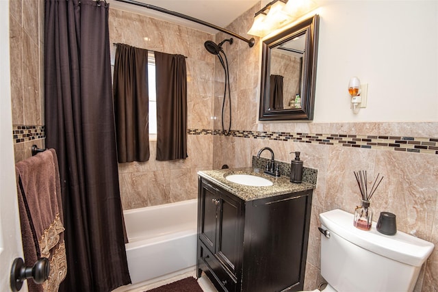 full bathroom with shower / bath combo, vanity, toilet, and tile walls