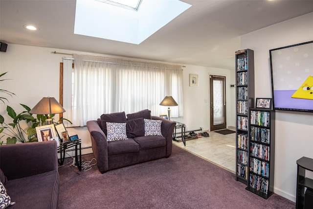 living room featuring carpet flooring, a skylight, and a baseboard heating unit