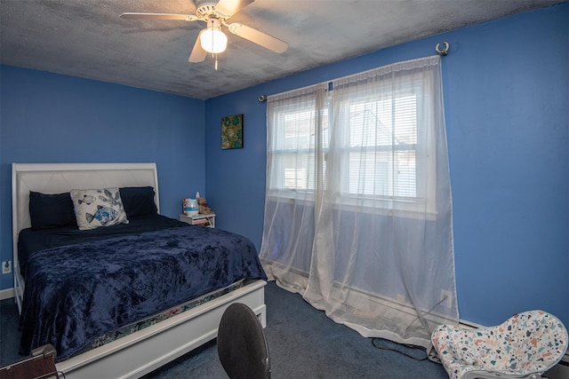 carpeted bedroom with a textured ceiling and ceiling fan