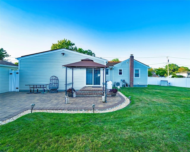 back of house with a gazebo, a patio, and a yard