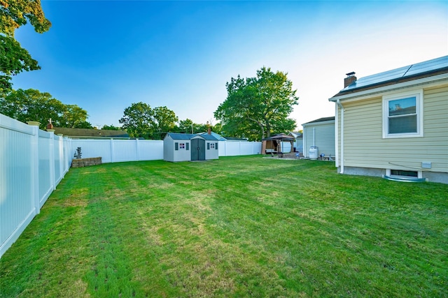 view of yard with a gazebo and a storage unit